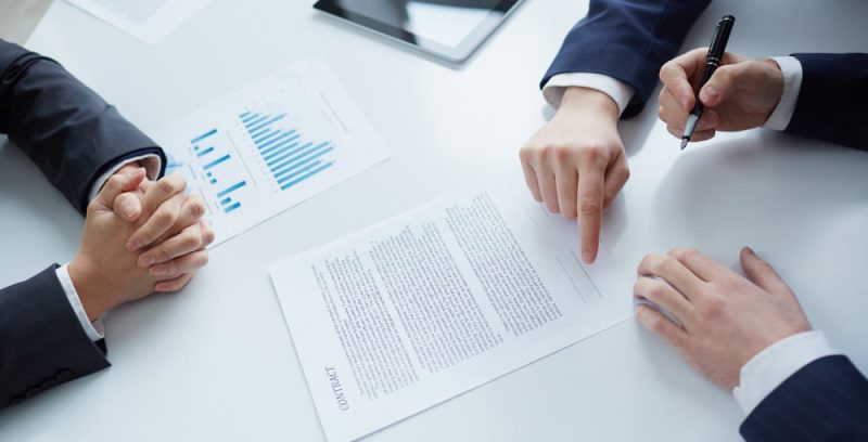 top-view-of-businessman-signing-documents(1)